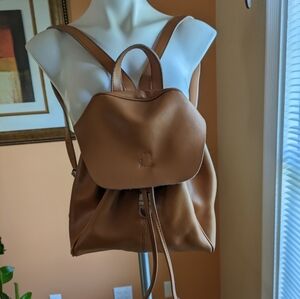 Tan leather backpack with silver hardware